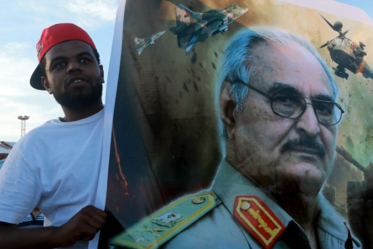 A man holds a picture of General Khalifa Haftar during a demonstration in support of the Libyan army under the leadership of General Khalifa in Benghazi