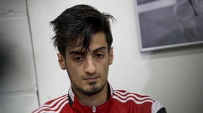 Mourad Laachraoui, the brother of a suspected ISIL fighter, at a press conference [Peter Dejong/AP]