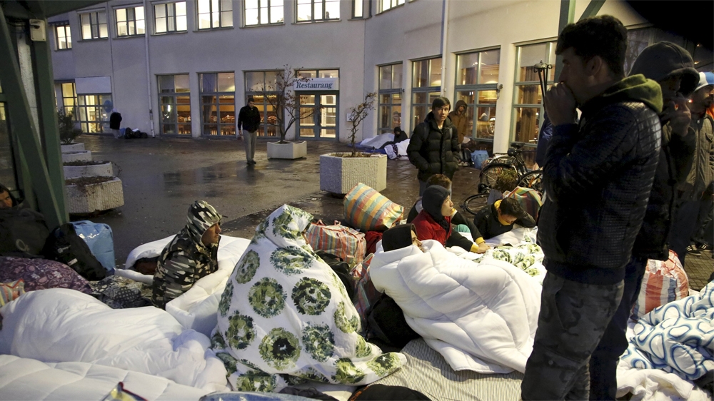 Refugees sleep outside the entrance of the Swedish Migration Agency's arrival centre for asylum seekers in Malmo. Property prices have shot up in Sweden  [Stig-Ake Jonsson/TT News/Reuters] 