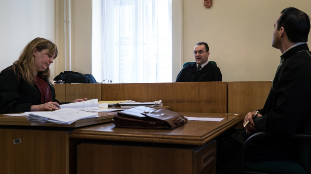 A judge and lawyers during a refugee's trial hearing [Sorin Furcoi/Al Jazeera]