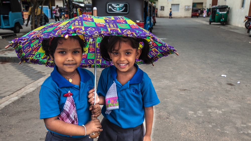 These two girls know Ari well. Sri Lanka's School Health Programme includes assessments of nutritional status, detection of health problems and provides immunisation [Suda Shanmugaraja/Al Jazeera]