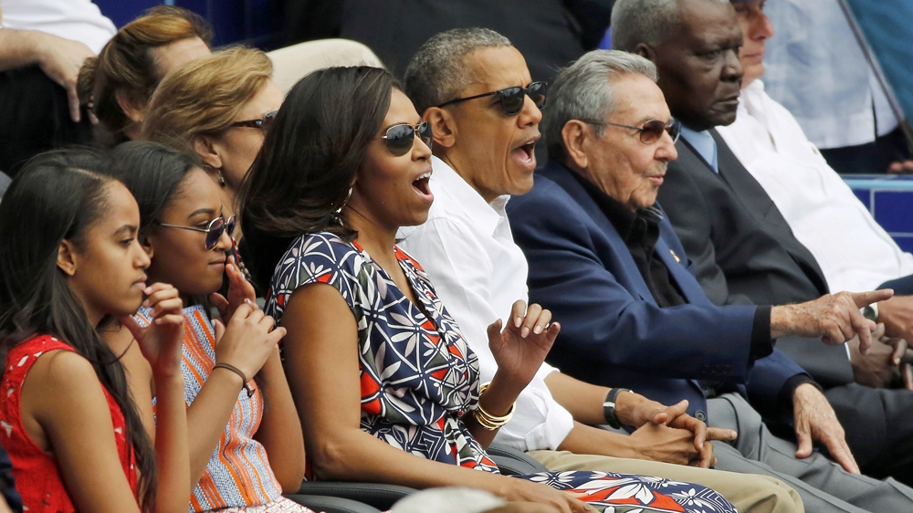 US President Barack Obama and his family watch an exhibition baseball game in Havana with Cuban President Raul Castro [Reuters]