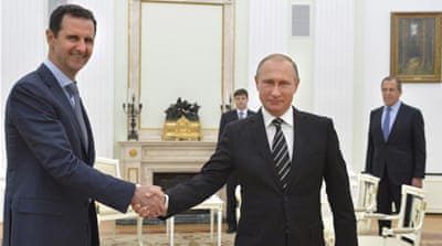 Russian President Vladimir Putin shakes hands with Syrian President Bashar al-Assad [Reuters]