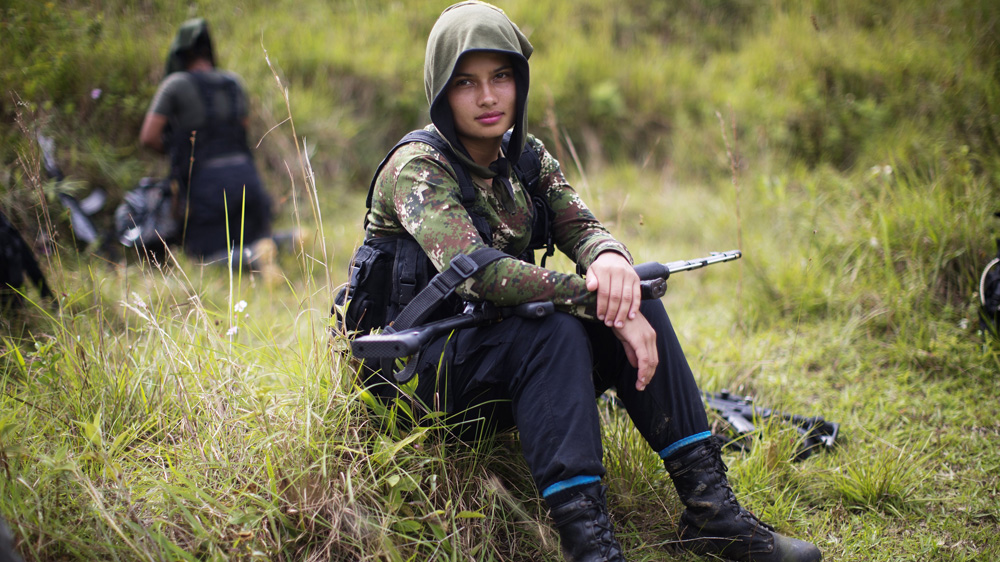 Juliana, a 20-year-old fighter for the FARC fled an impoverished home at 16 and followed in the footsteps of an uncle to join the FARC after being raped by her stepfather [Rodrigo Abd/AP]