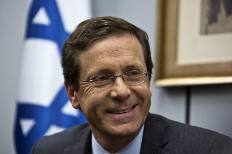 File photo of Herzog smiling at party headquarters in Tel Aviv
