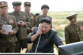 North Korean leader Kim Jung Un guides the test fire of a tactical rocket in this undated file photo