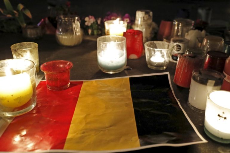 Candles are pictured around a Belgian flag on the Place de la Republique in Paris
