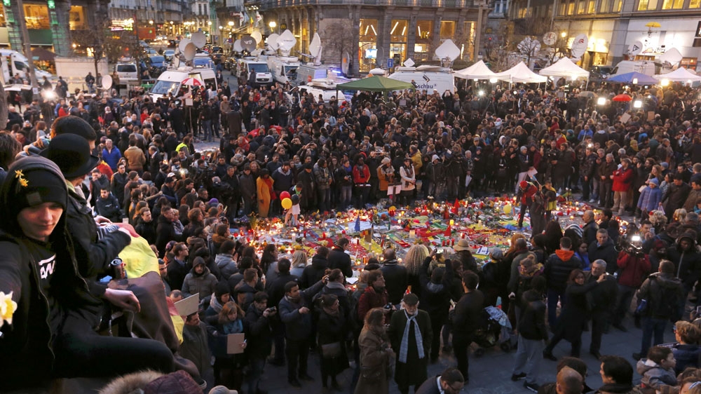 People attend a street memorial service near the old stock exchange in Brussels after Tuesday's bomb attacks in Brussels [Reuters/Vincent Kessler (Daylife)]