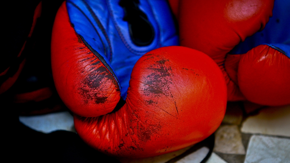 The old, worn-out boxing gloves used by the women boxers are kept for fight days. They mostly train with their bare fists [Edward Echwalu/Al Jazeera] 