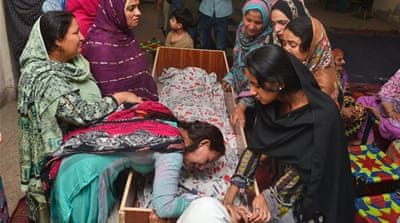Pakistani relatives mourn over the body of a victim during a funeral following an overnight suicide bombing in Lahore [AFP]