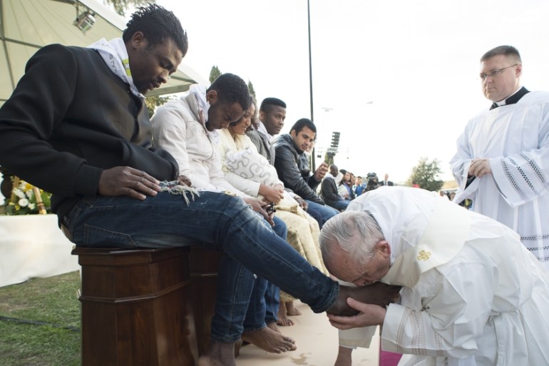 Pope washing feet of refugees