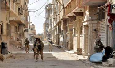 Forces loyal to Syria''s President Bashar al-Assad walk with their weapons in Palmyra city after they recaptured it