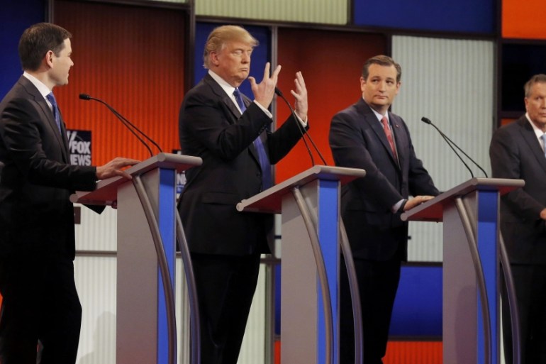 Republican U.S. presidential candidate Trump shows off the size of his hands as rivals Rubio, Cruz and Kasich look on at the start of the U.S. Republican presidential candidates debate in Detroit