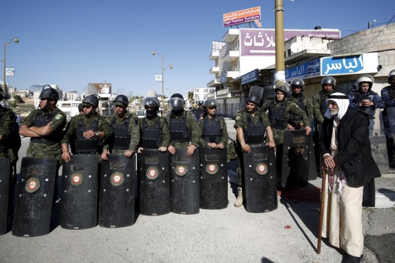 Members of Palestinian security forces stand guard during a rally in support of Palestinian journalist Mohammad al-Qiq,in the West Bank city Ramallah