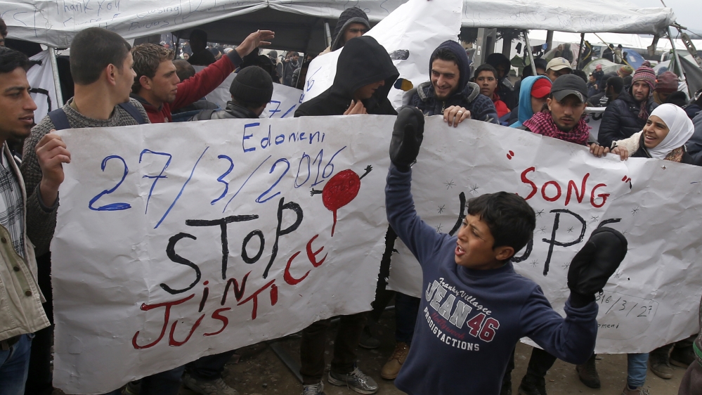 Refugees shout slogans during a protest demanding the opening of the border between Greece and Macedonia in the northern Greek border station of Idomeni [Darko Vojinovic/AP]