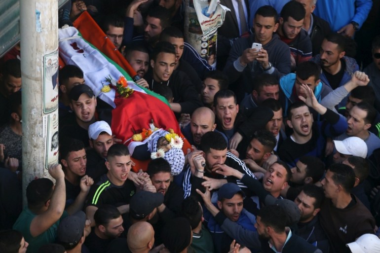 Mourners carry the body of 22-year-old Palestinian man Eyad Sajedeya, who medics said was shot dead by Israeli forces, during his funeral at Qalandia refugee camp near the West Bank city of Ramallah