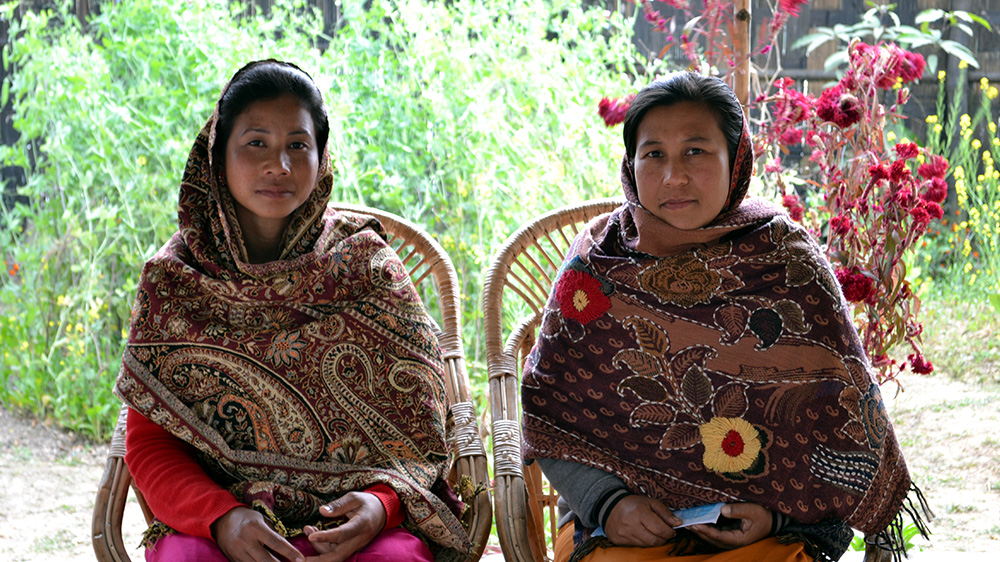 Farida Bibi and Mumtaz Begum work as community mobilisers for Manipur Women Gun Survivors Network, helping other widows who lost their husbands to gun violence [Sarita Santoshini/Al Jazeera]
