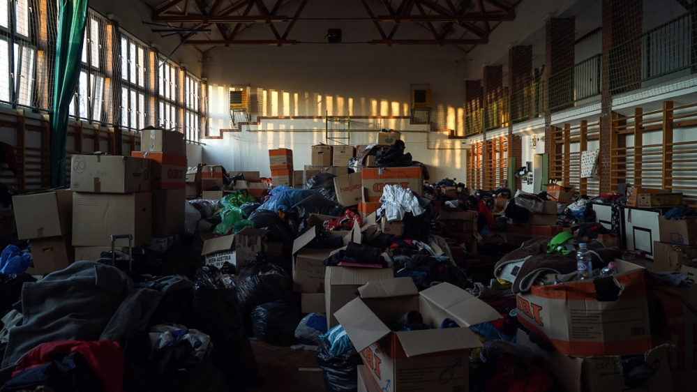 The sports hall of the old abandoned school turned into a warehouse for refugee donations [Sorin Furcoi/Al Jazeera]