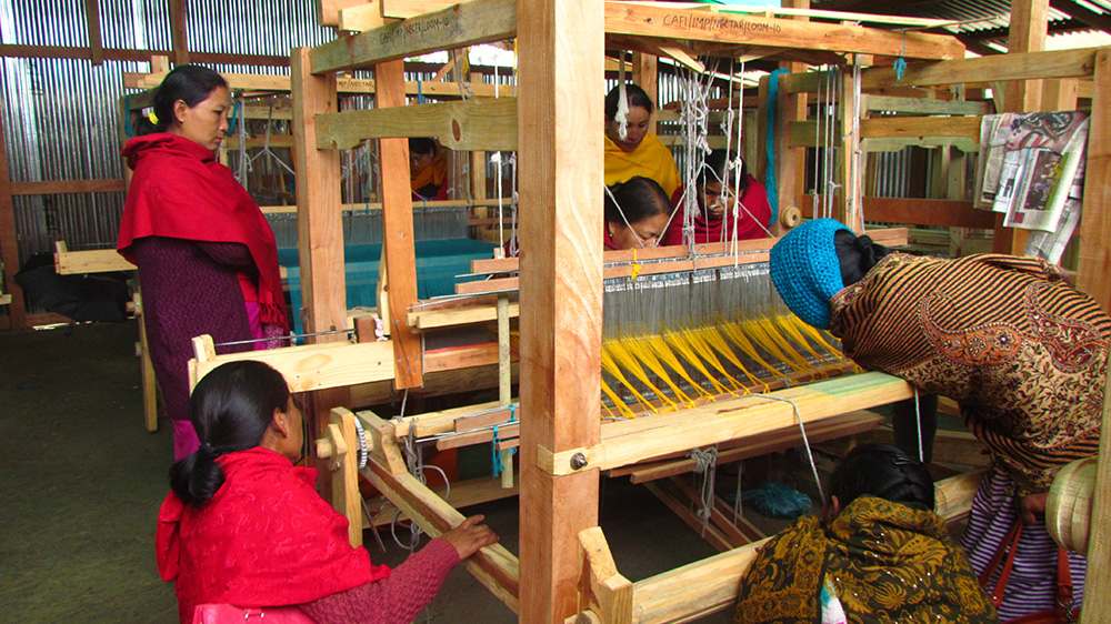 Manipur Women Gun Survivors Network has used weaving as a form of psycho-social therapy to help a number of conflict widows deal with loss and trauma as well as support themselves financially [Sarita Santoshini/Al Jazeera]