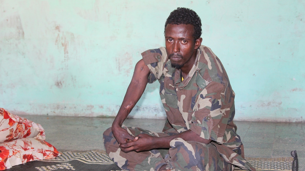 Ahmed Mohamed Ibrahim was hit in the arm by three bullets, which shattered the bone, as he guarded the presidential palace from al-Shabab fighters in 2010 [Ahmed Farah /Al Jazeera]