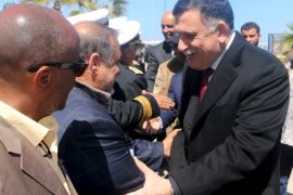 Libyan Prime Minister-designate Fayez Seraj is greeted upon arrival in Tripoli