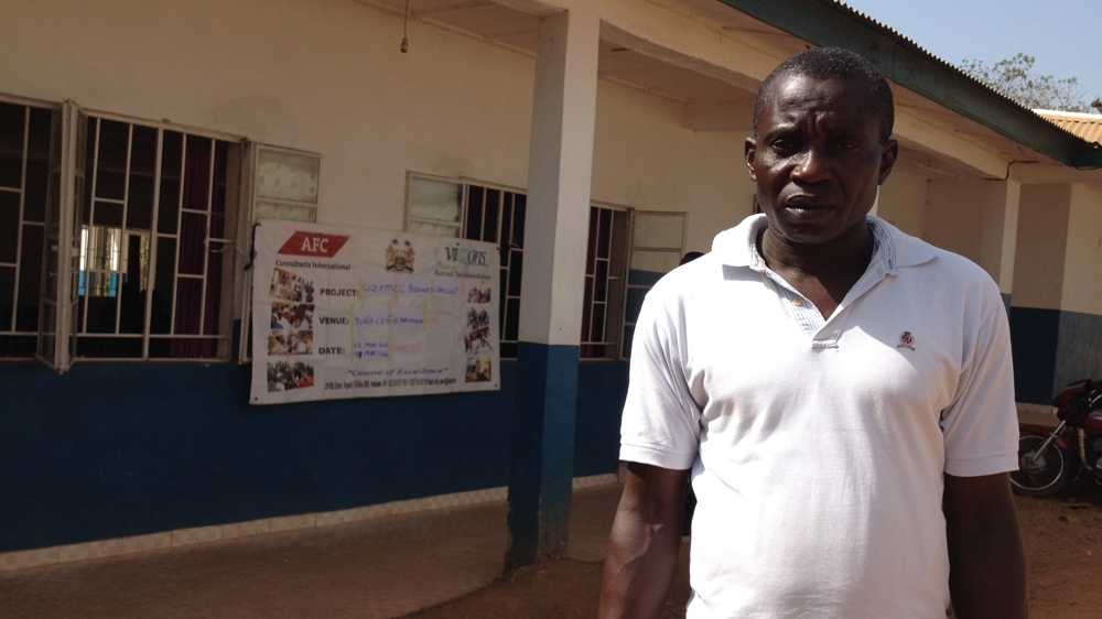 After years on the street, Umaru Jusu, pictured outside his class in Kailahun, joined the Integrated Farmers Training programme and now harvests and sells cocoa beans [Nina Devries/Al Jazeera]
