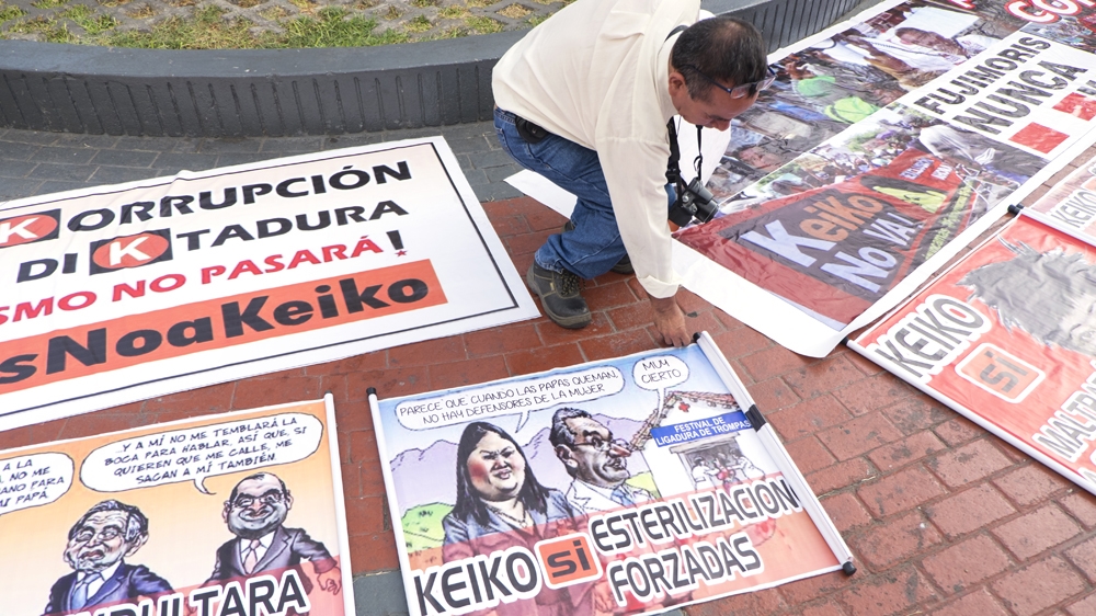 Protesters opposed to presidential candidate Keiko Fujimori display cartoons [Eline van Nes/Al Jazeera]