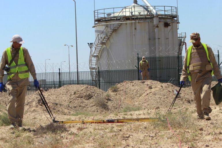 De-mining teams search for landmines in Rumaila oilfield in Basra province, Iraq