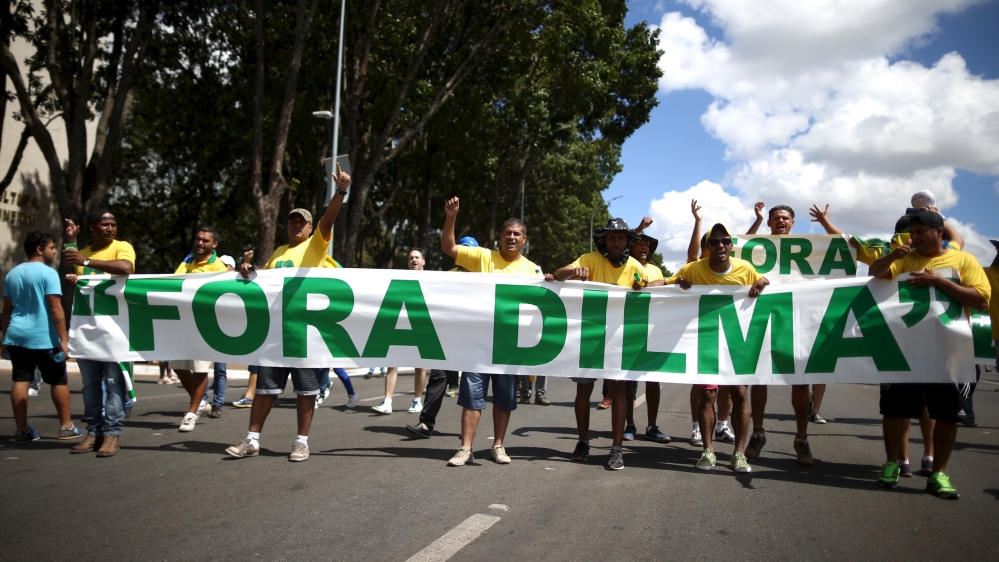 Protesters hold a banner reading 'Dilma out' before Sunday's impeachment vote [Adriano Machado/Reuters]
