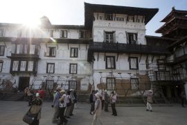 Japanese tourists visits the Kathmandu Durbar Square surrounded by supported wooden poles, Kathmandu, Nepal [EPA]