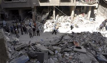 Residents inspect a site hit by what activists said were barrel bombs thrown by forces loyal to Syria''s President Bashar Al-Assad, in the Palestinian Yarmouk refugee camp, southern outskirt