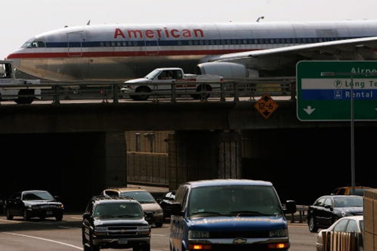 A passenger jet passes over traffic at JFK airport [Getty]