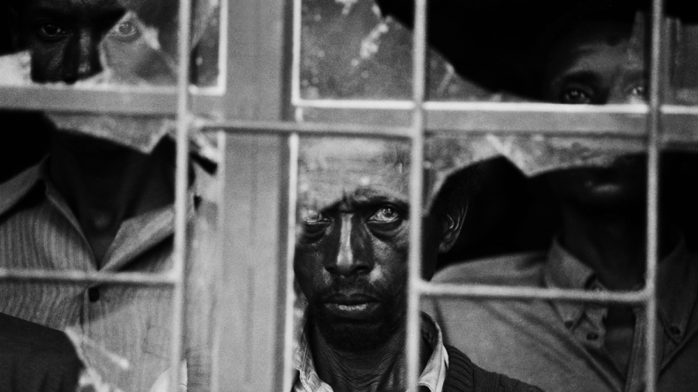Hutus being held prisoner in the vestibule of a Catholic church. They were part of a government-sponsored armed group responsible for mass killings in Gikoro district [Jack Picone/Al Jazeera]