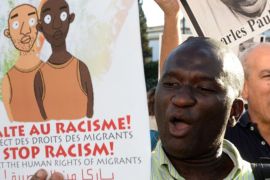 Protesters shout slogans as they hold placards during a demonstration in Rabat against racism in Morocco in 2014 [AFP]