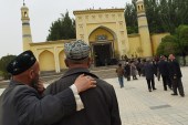 Uighur men making their way to the Id Kah mosque for afternoon prayers in Kashgar, in China's western Xinjiang region [AFP]