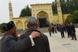 Uighur men making their way to the Id Kah mosque for afternoon prayers in Kashgar, in China''s western Xinjiang region [AFP]