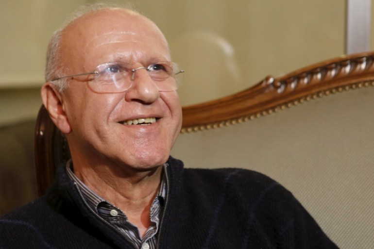 Former Lebanese Information Minister Michel Samaha smiles at his house after being released in Beirut