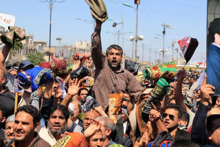 Followers of Iraq''s influential Shia cleric Muqtada al-Sadr chant slogans calling for governmental reforms during a demonstration in Sadr City in Baghdad, Iraq [AP]