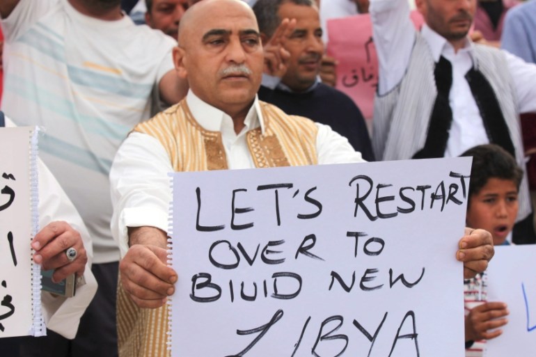 Supporters of Libya''s unity government hold signs during a demonstration in Tripoli