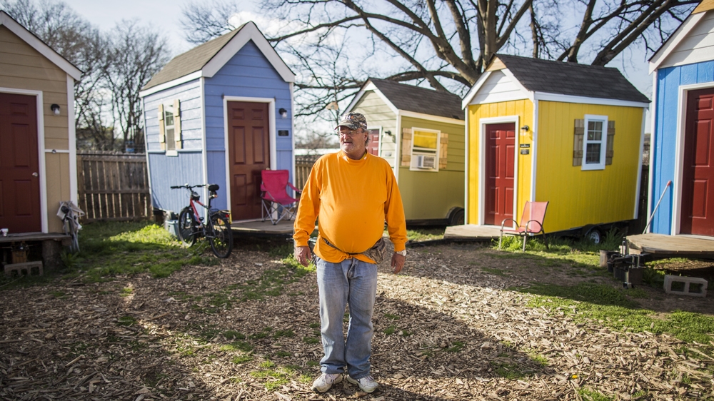 Peter Regan, who has been a resident of the camp for about a year, describes the tiny houses as a 'stair step' to his own permanent residence [Joe Buglewicz/Al Jazeera] 