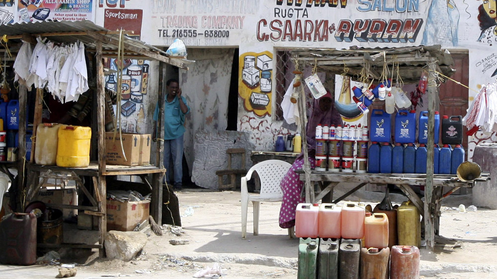 Jerry cans with petrol and motor oil are for sale on a street in Mogadishu in 2006 [Radu Sigheti/EPA]