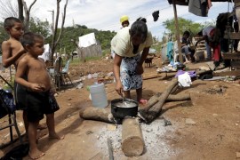Paraguayan woman cooks in one of Paraguay''s poor neighborhoods in Asuncion