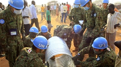 UN Mission in South Sudan peacekeepers from Japan assemble a drainage pipe at Tomping camp in Juba [Reuters]