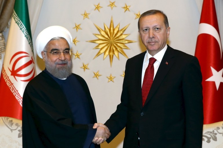 Presidential Palace handout photo shows Turkish President Erdogan shaking hands with his Iranian counterpart Hassan Rouhani during a welcoming ceremony at the Presidential Palace in Ankara