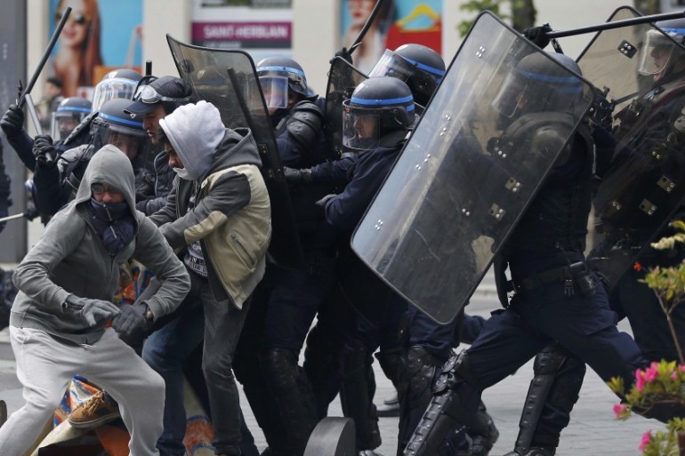 French riot police officers clash with protestors during a demonstration against the French labour law proposal in Nantes
