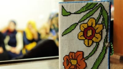 D embroidered a book for her mother while in prison [  Abed al Qaisi/  Al Jazeera]