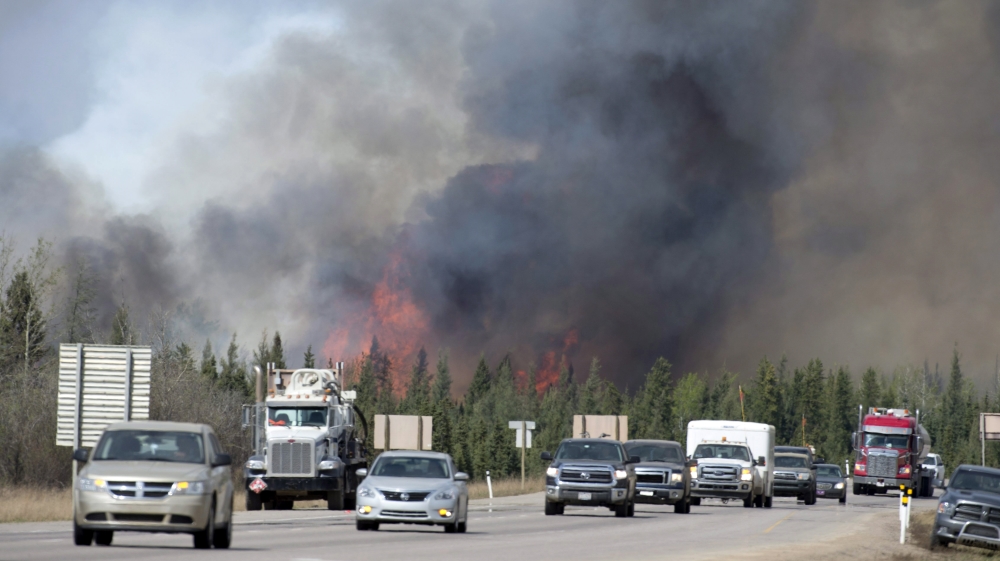 The mass evacuation going on because of the fire has forced as much as a quarter of Canada's oil output offline [AP]