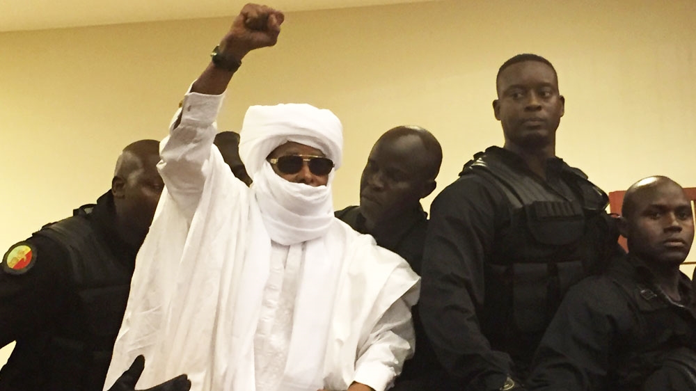 Habre raises his hand in defiance following the court proceedings in Dakar on Monday [AP]