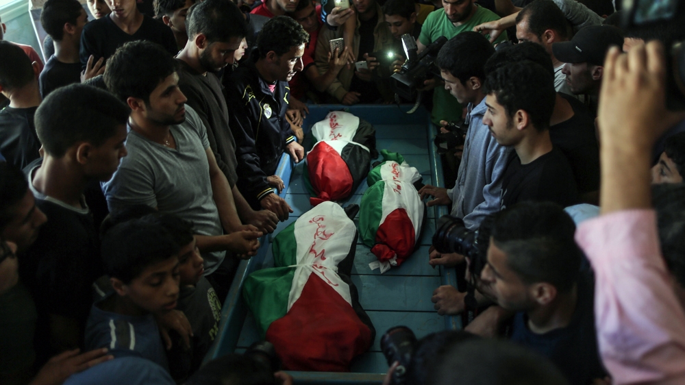 Mourners attend the funerals of Hendi children [Ezz Zanoun/Al Jazeera]