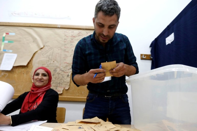 A Lebanese election official counts ballots after their polling station closed during Beirut''s municipal elections
